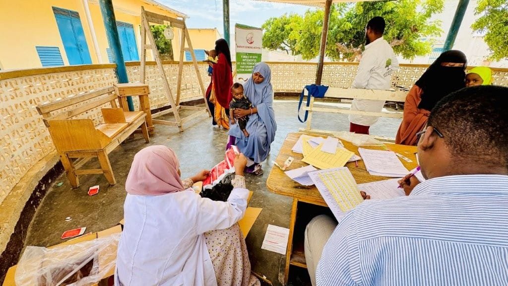 Axiom ME enumerator conducting a field interview at a health facility